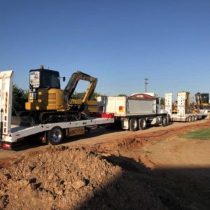 Upt Drop Deck And Single Axle Trailer Fleet Loaded With Cat Excavators Towed By Mack Trucks