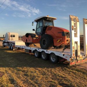 Drop Deck Tri Axle With Roller Pulled By A Mack Truck