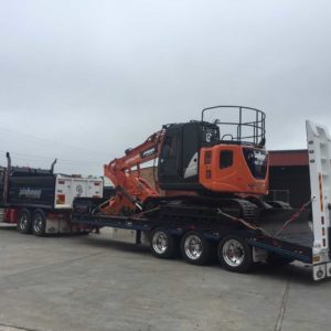 Upt Tri Axle Pulled By A Mack With A Hitachi Loaded